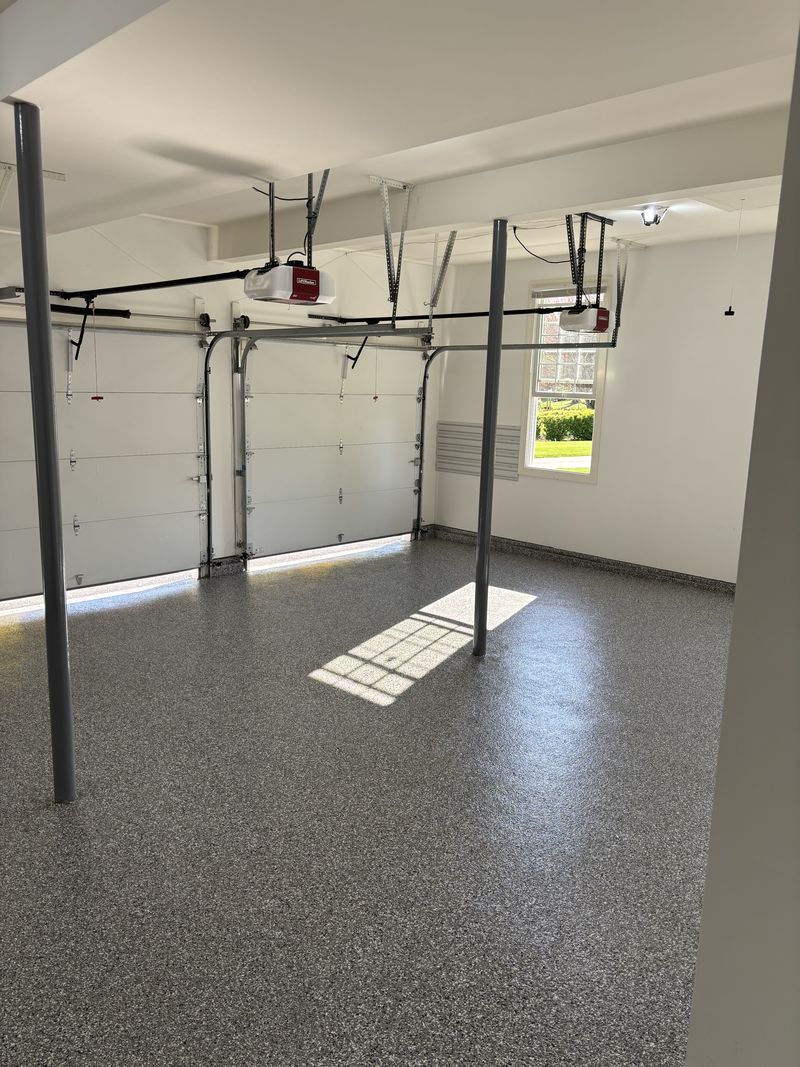 Full-flake polyaspartic garage floor with coved wall base, southeastern Pennsylvania