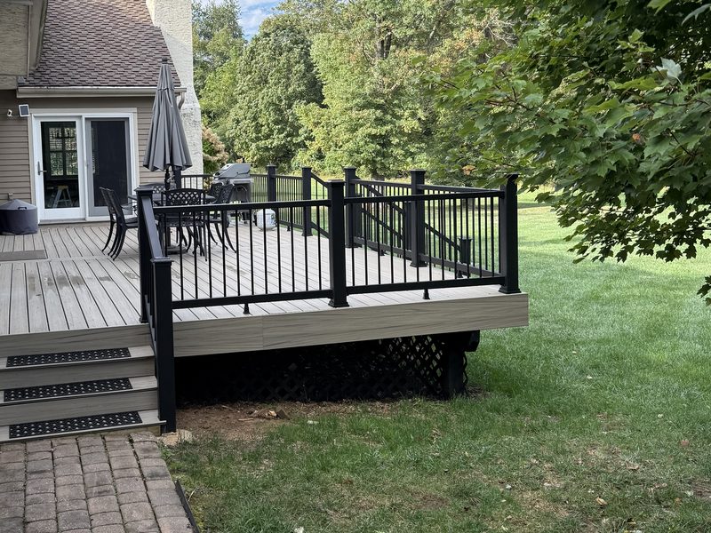 Composite deck with black aluminum railing replacing a failing wood deck, Chester County PA