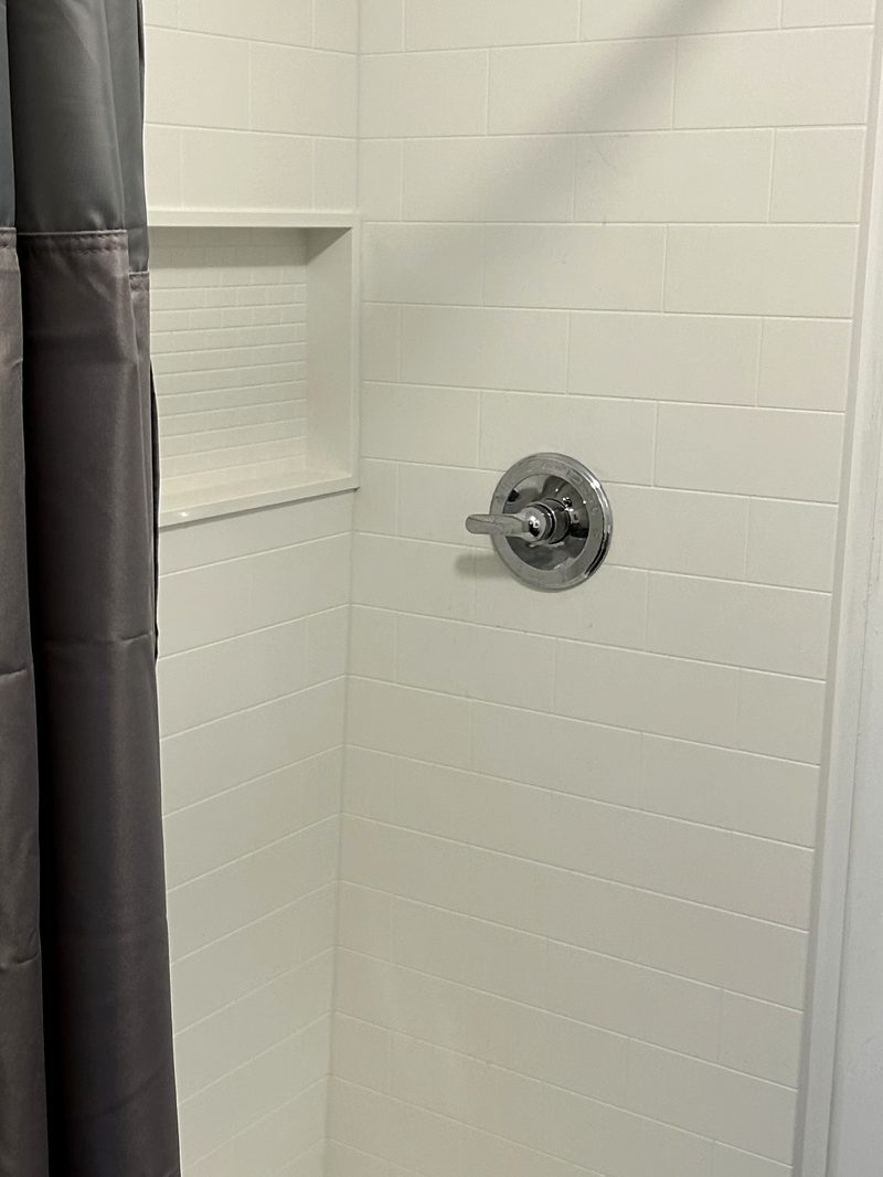 LuxeDay Baths one-day shower install with grout-free wall panels, recessed niche and solid-surface base, Chester County PA