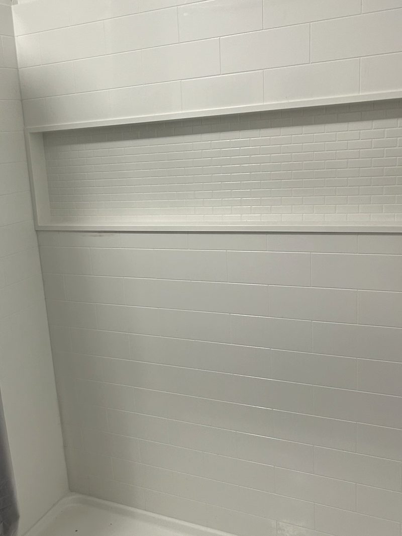 Grout-free shower wall panels with glass mosaic accent niche, LuxeDay one-to-two day bathroom install in southeastern Pennsylvania